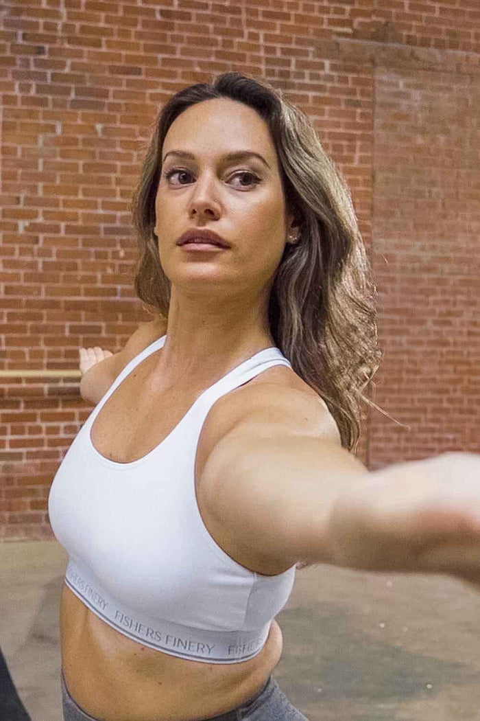 White silk bralette with wide straps and elastic underband on model.