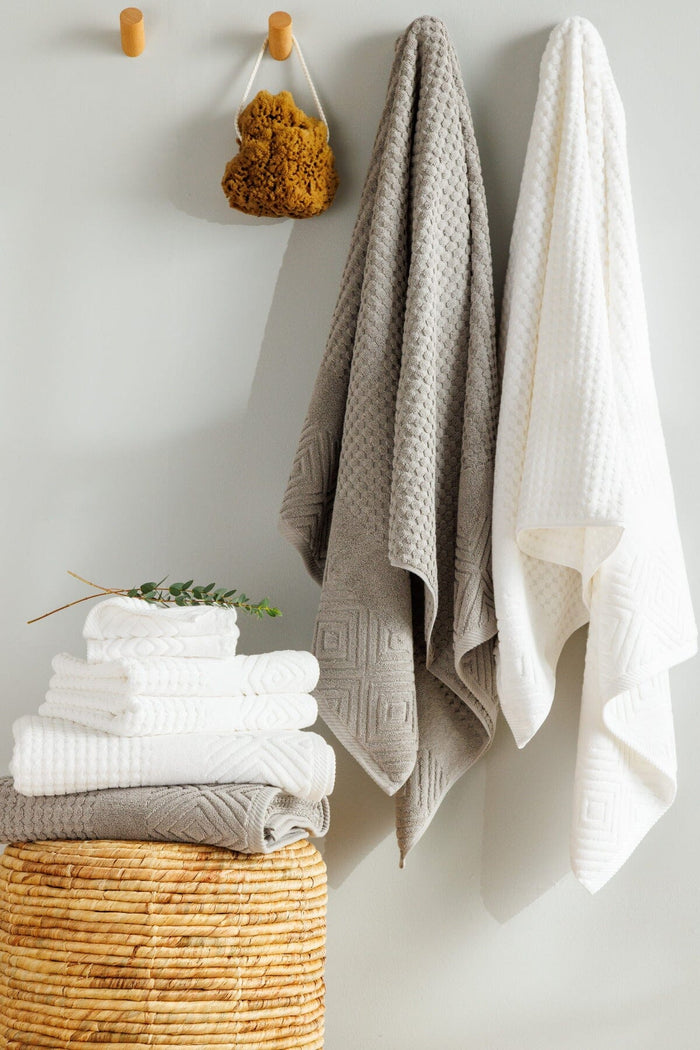 Texere 100% Organic Cotton Diamond Jacquard Towel Set Hanging on Hooks with stack of towels Home>Bathroom>Towels Fishers Finery 