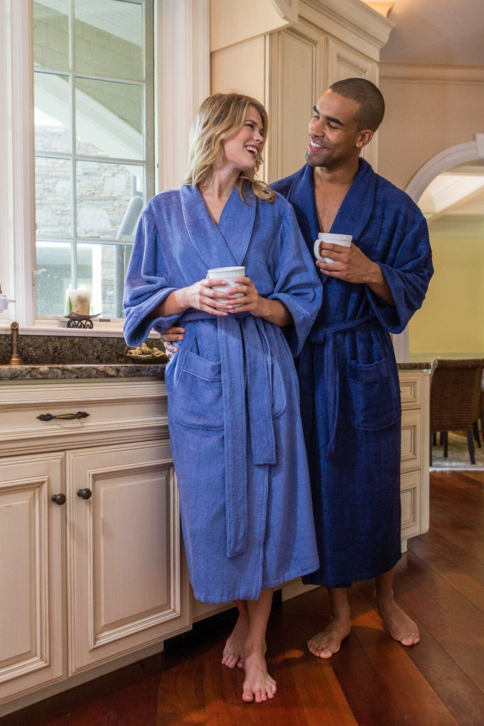 Kashmir blue silk robe with belt worn by woman and man in kitchen setting.