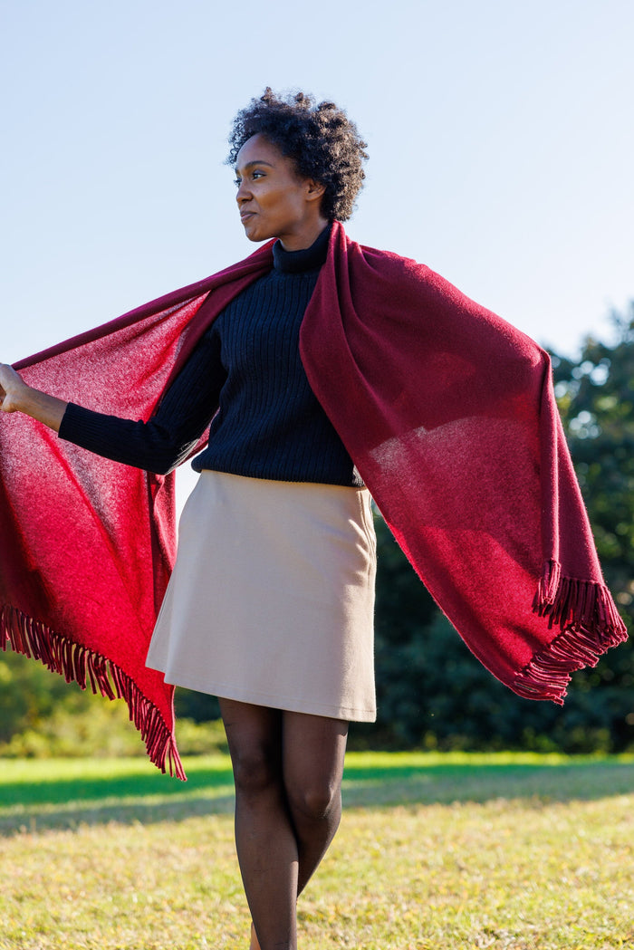 Burgundy silk shawl with fringed edges draped over shoulders.