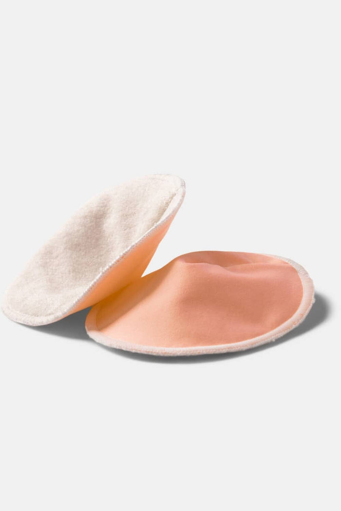 Round peach silk nursing pads with soft textured backing, pack of two.