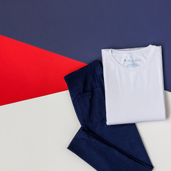 White crew neck tee and navy leggings on a red, white and blue background for Fishers Finery's 4th of July sale. Buy one pair of leggings and get a free crew neck tee.