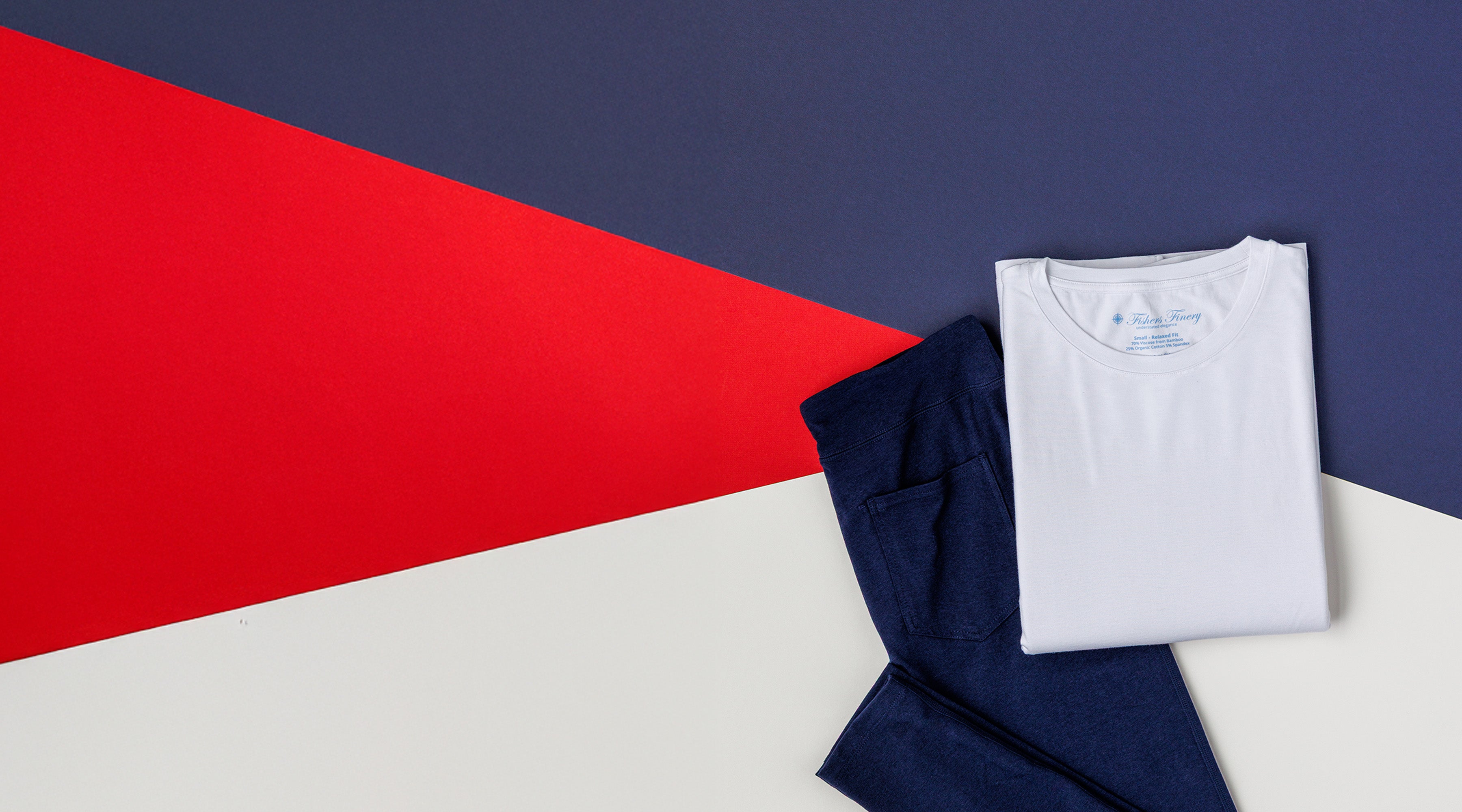 White crew neck tee and navy leggings on a red, white and blue background for Fishers Finery's 4th of July sale. Buy one pair of leggings and get a free crew neck tee.