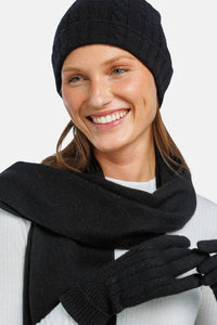 women wearing black cashmere hat glove and scarf set over a white top