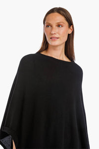 women wearing a black cashmere poncho close-up.