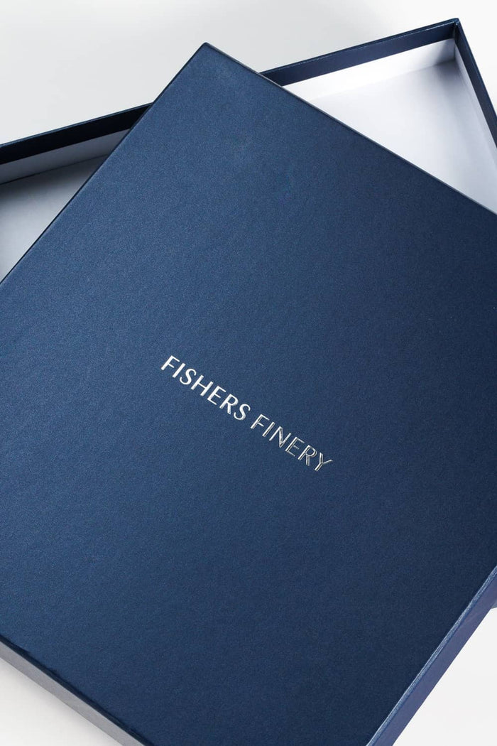 Navy silk shirt neatly folded inside a navy blue Fishers Finery box.