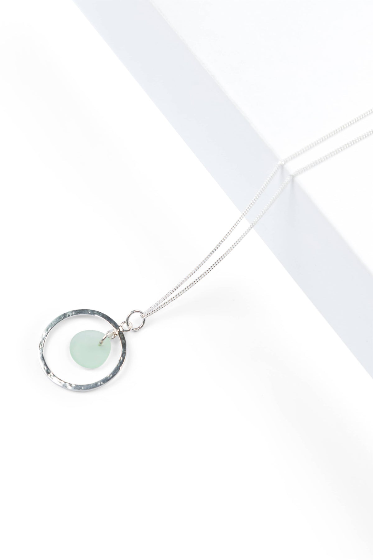 Silver pendant necklace with seafoam sea glass detail on thin chain.
