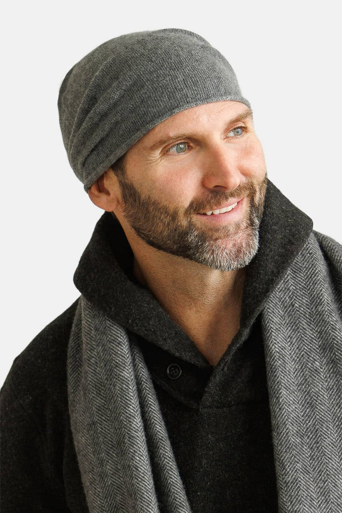 Charcoal silk beanie hat worn with matching scarf on smiling man.
